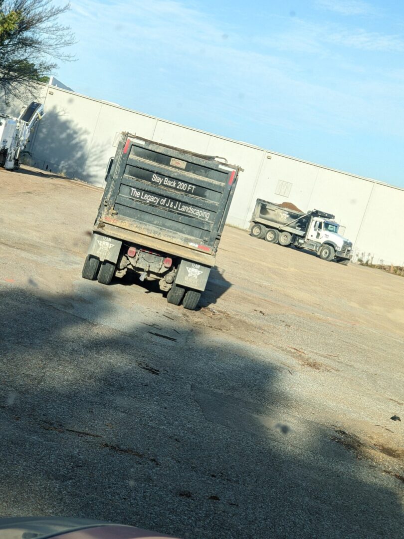 A dump truck is driving down the street.