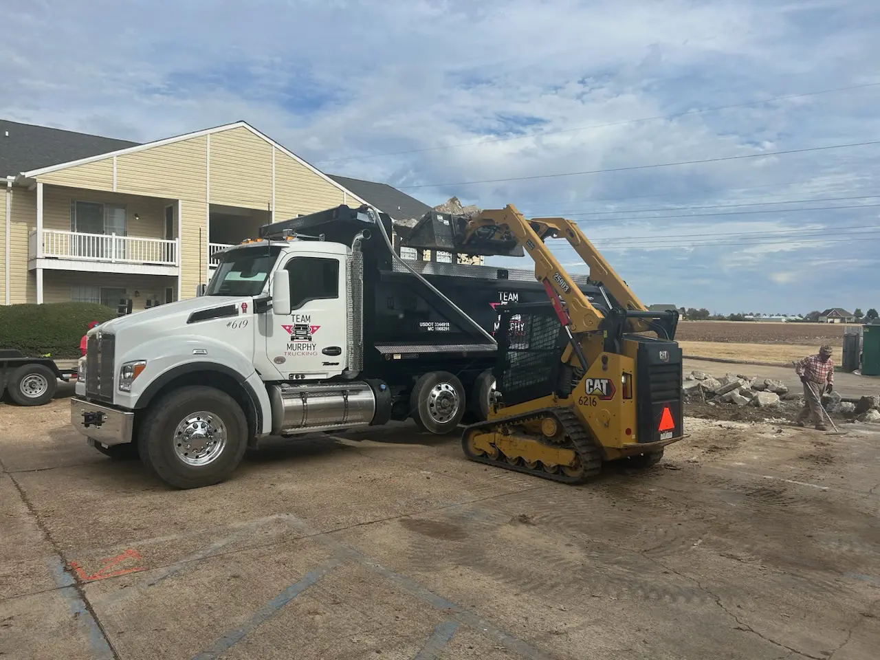 A large truck is parked in front of a building.